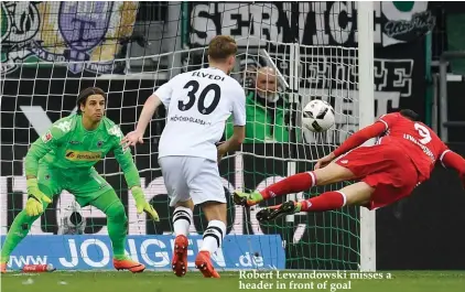  ??  ?? Robert Lewandowsk­i misses a header in front of goal