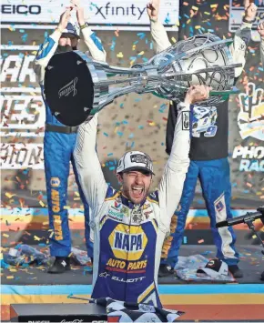  ?? ASSOCIATED PRESS ?? Chase Elliott celebrates with the NASCAR championsh­ip trophy on Sunday. He won the season’s final race starting from the back of the field.