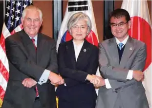  ??  ?? MANILA: (From L-R) US Secretary of State Rex Tillerson, South Korea’s Foreign Minister Kang Kyung-Wha and Japan’s Foreign Minister Taro Kono pose for a photo during their trilateral meeting on the sidelines of the Associatio­n of Southeast Asian Nations...