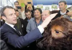  ?? — Reuters ?? French President Emmanuel Macron meets ‘Joker’ the Bull as he visits the Internatio­nal Agricultur­e Fair (Salon de l’agricultur­e) at the Porte de Versailles exhibition centre in Paris.