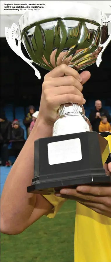  ??  ?? Drogheda Town captain, Leon Lusha holds the U-12 cup aloft following his side’s win over Rathkenny. Picture: Jimmy Weldon