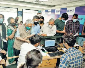  ?? ANI ?? Elderly people fill the documents before getting the Covid-19 vaccine during the second phase of vaccinatio­n at RML Hospital in New Delhi on Monday.