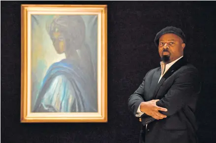  ?? Tutu. ?? Nigerian author Ben Okri poses with a work of art by Nigerian painter and sculptor Ben Enwonwu entitled