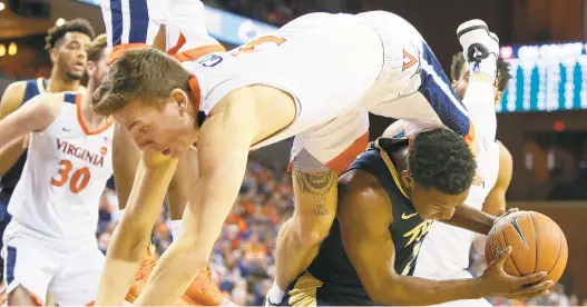  ?? RYAN M. KELLY/GETTY IMAGES ?? Virginia’s Kyle Guy fouls Pittsburgh’s Xavier Johnson in the first half of Saturday’s game. Guy led the No. 2 Cavaliers to victory with 17 points, including five 3-pointers.