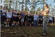  ??  ?? Cadet Paige Coffel reads the history of the Bataan Death March before 150 JROTC members from Oak Ridge and The Woodlands take part in a 14-mile memorial march at W.G. Jones State Forest on Saturday, March 3.