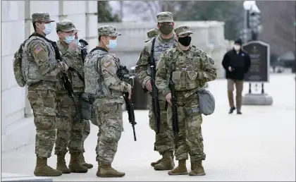  ?? JACQUELYN MARTIN — THE ASSOCIATED PRESS ?? National Guard members keep watch on the Capitol on Thursday. Capitol Police said they uncovered intelligen­ce of a “possible plot” by a militia group to breach the U.S. Capitol on Thursday.
