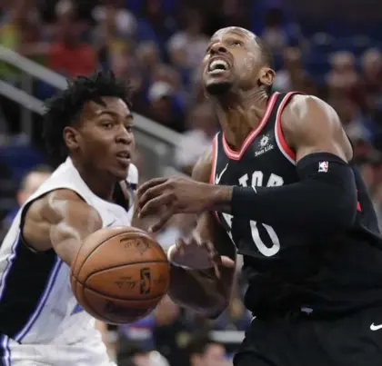  ?? JOHN RAOUX/THE ASSOCIATED PRESS ?? Orlando’s Wesley Iwundu, left, knocks the ball out of the hands of C.J. Miles, but it was the Raptors who knocked off Orlando 117-104, with six players scoring in double figures for Toronto.