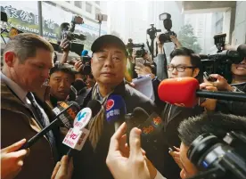  ?? (Reuters) ?? HONG KONG media tycoon Jimmy Lai is surrounded by journalist­s outside police headquarte­rs in Hong Kong in January 2015.