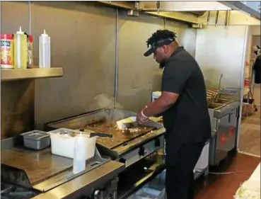  ?? CHAD FELTON — THE NEWS-HERALD ?? Tremaine Gilson prepares a chicken Philly sub at SubCity in Euclid. Gilson and his partner, Darryl Clement, operate three of the eateries, and one food truck, throughout Northeast Ohio.