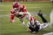  ?? CHARLIE RIEDEL — THE ASSOCIATED PRESS ?? Kansas City Chiefs quarterbac­k Patrick Mahomes (15) dives after running the ball ahead of Cincinnati Bengals defensive end Trey Hendrickso­n, right, during the second half of the AFC championsh­ip NFL football game, Sunday, Jan. 30, 2022, in Kansas City, Mo.