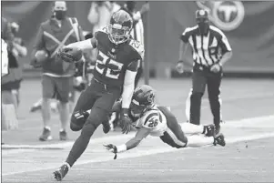  ?? WADE PAYNE/AP ?? Titans running back Derrick Henry avoids a tackle on a 53-yard gain on a screen pass in overtime Sunday.