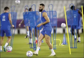  ?? (AP/Christophe Ena) ?? France’s Karim Benzema participat­ed in the team’s practice Saturday, but he tore a muscle in his left thigh and will not be available to play in the World Cup.