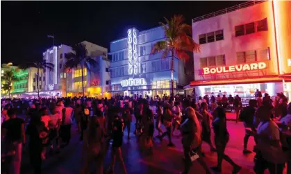  ?? Photograph: DA Varela/AP ?? Crowds walk along Ocean Drive in Miami Beach, Florida, on Friday night.