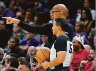  ?? Matt York / Associated Press ?? Phoenix Suns head coach Monty Williams, rear, talks with an official during the first half of Game 1 in the second round of a NBA Western Conference playoff series on May 2 in Phoenix.