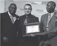  ??  ?? Mr Zak Hawa (centre) holds a certificat­e he received for being the Megafest Industrial­ist of the Year 2017 from the guest of honour Mr Dzingirai Tusai (right) while the CEO of Megafest Dr Tafadzwa Matsika (left) congratula­tes him during the Megafest...