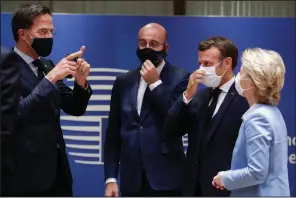  ?? (AP/Stephanie Lecocq) ?? Dutch Prime Minister Mark Rutte (from left) talks with European Council President Charles Michel, French President Emmanuel Macron and European Commission President Ursula von der Leyen on Tuesday at the European Union summit in Brussels. More photos at arkansason­line.com/722summit/.