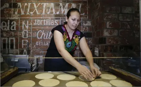  ?? JOSIE LEPE — STAFF ARCHIVES ?? Maricela Cervantes prepares tortillas at Luna Mexican Kitchen in San Jose in 2017. Tortillas are pressed by hand daily from organic, non-GMO corn.
