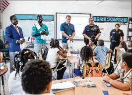  ?? COURTESY OF MIAMI DOLPHINS ?? NFL Commission­er Roger Goodell (middle) joined Dolphins players for their event with the North Miami Police Department on Tuesday.