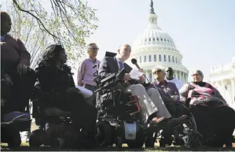  ?? Chip Somodevill­a / Getty Images ?? Kent Keyser (center) talks about how the repeal of the Affordable Care Act would negatively impact him and other disabled people during a news conference outside the U.S. Capitol.