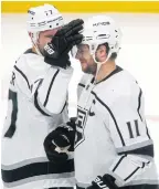  ??  ?? The Kings’ Jeff Carter, left, congratula­tes Anze Kopitar at the end of the game.