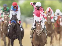  ?? Patrick Smith / Getty Images ?? Jockey Flavien Prat, riding Rombauer, celebrates in front of jockey John Velazquez, riding Medina Spirit, left, as he wins the Preakness Stakes on Saturday at Pimlico Race Course in Baltimore.