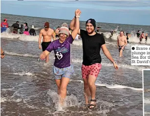  ?? ?? ● Brave supporters plunge into the Irish Sea lfor the second St David’s Dip.