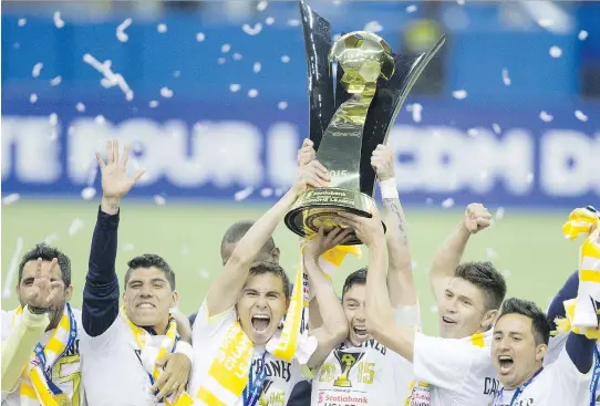  ?? JOHN KENNEY/MONTREAL GAZETTE ?? Players from Club America of Mexico City hoist the championsh­ip trophy at the end of the second leg of the CONCACAF Champions League final at Olympic Stadium, Wednesday. Club America won the final leg 4-2 to capture the title 5-3 on aggregate.