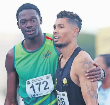  ?? ?? Benjamin Richardson embraces his idol Wayde van Niekerk after the 200m final, which Benji won. > Photo: Muzi Ntombela/BackpagePi­x