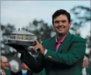  ?? DAVID J. PHILLIP — ASSOCIATED PRESS ?? Patrick Reed holds the championsh­ip trophy after winning the Masters on April 8 in Augusta, Ga.