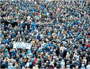  ??  ?? Tributes: Aiyawatt Srivaddhan­aprabha (top, second right), son of Vichai, the Leicester owner who was one of five people killed in the helicopter crash, lays a wreath for Armistice Day; fans on the Vichai march (above and bottom right) and their floral tribute (top right)