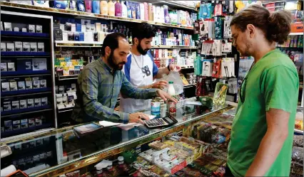  ?? Photo: AFP ?? Price hike… An Iranian shop at a food store in the capital Tehran on 13 May 2021, as prices on basic goods soar. Hundreds of people have taken to the streets in cities across Iran to protest the government’s decision to raise the prices of essential goods, state media reported today.