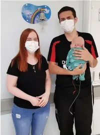  ??  ?? Taliesin Howells was born three months prematurel­y weighing 2lb 10oz. He’s pictured with his parents Rhys and Liz Howells.