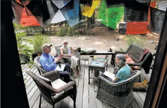  ?? Michael Macor / The Chronicle ?? Chris Van Hook (left), director of the Clean Green Certified program, meets with Swami Chaitanya and Nikki Lastreto before inspecting their cannabis farm in Mendocino County.