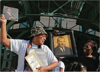  ?? James Nielsen photos / Houston Chronicle ?? Pricilla Owens, left, and Vicky Williams, right, display memorabili­a during the Black Heritage Society’s 39th annual Martin Luther King Jr. Parade on Monday in downtown.