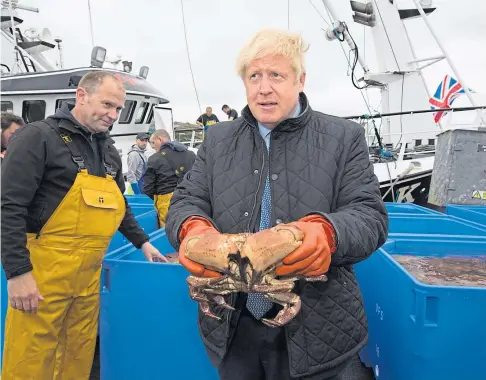  ??  ?? SEAFOOD ROW: Prime Minister Boris Johnson on a visit to Stromness Harbour in July last year.