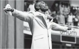  ?? Mark Humphrey / Associated Press ?? Terrell Owens forms the letter “T” after he delivered his speech at the University of Tennessee-Chattanoog­a, where he was a three-sport star.