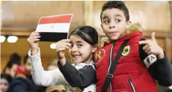  ?? — AFP ?? CAIRO: Egyptian children celebrate with a national flag marked with the words ‘Tiran’ and ‘Sanafir’ after the Supreme Administra­tive Court upheld yesterday a ruling voiding a government agreement to hand over the two Red Sea islands to Saudi Arabia.
