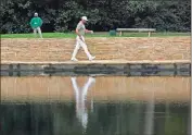  ?? USA Today Sports - Rob Schumacher ?? Jason Day walks across the Sarazen Bridge at Augusta National during a practice round Monday.