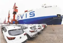  ?? AFP / Getty Images ?? MG cars produced in China await loading onto a ship to the U.S. The planned tariffs are expected to hit automakers hard.