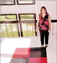  ?? RACHEL DICKERSON/MCDONALD COUNTY PRESS ?? Julie Holloway, principal at McDonald County High School, is pictured with some of the new tile at the school, which features red and black accents. The 100 and 200 hallways also got new paint and lighting.