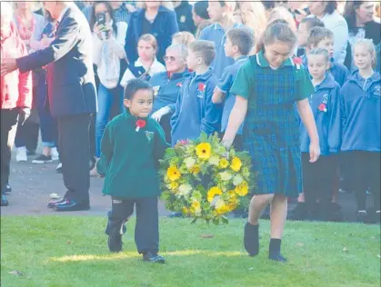  ??  ?? Vyrn Aldworth and Te Ataihaea Paewai present a wreath on behalf of Te Kura Kaupapa Maori o Tamaki Nui a Rua.