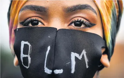  ??  ?? A NATION OF COLOUR A woman with a mask at a Black Lives Matter protest in Edinburgh’s Holyrood Park in June. Pic: Jeff J Mitchell/ Getty Images