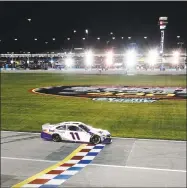  ?? Kyle Rivas / Getty Images ?? Denny Hamlin crosses the finish line to win at Kansas Speedway last month in Kansas City, Kan.