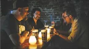  ?? Casey McCauley / AP ?? Left to right, Marvel writer Skottie Young, assistant editors Danny Khazem and Kathleen Wisneski, and executive editor Nick Lowe sit inside the historic Lafitte's Blacksmith Shop in the French Quarter of New Orleans.