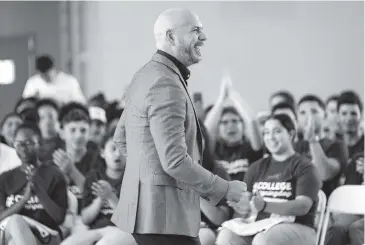  ?? PHOTOS BY MATIAS J. OCNER mocner@miamiheral­d.com ?? Rapper Armando ‘Pitbull’ Perez gives a motivation­al talk to students after they signed with universiti­es during an event at SLAM Academy Miami in Little Havana on Wednesday.