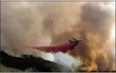  ?? RINGO H.W. CHIU — THE ASSOCIATED PRESS ?? An air tanker drops retardant on a wildfire in Goleta on Wednesday.