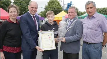  ??  ?? Alex Fortune (13), Ballyhogue, from Fortune’s Fruit and Veg, winner of the All-Ireland Farmer’s Market. He was presented with his prize by Liz Hore, Minister Paul Kehoe TD, Cllr. Keith Doyle, chairman Enniscorth­y Municipal District, and Pat Roche,...