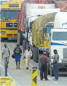  ?? /Katherine Muick/ Sunday Times ?? Driving into a new future: Loaded trucks queue on the Zimbabwe side of Beitbridge border post waiting to enter SA. The busy border post is to be refurbishe­d and expanded.