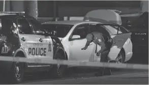  ?? IAN KUCERAK / POSTMEDIA ?? Edmonton police investigat­e after a man struck an officer with a car Saturday evening. The suspect then ran over four others with a U-Haul van before being stopped.