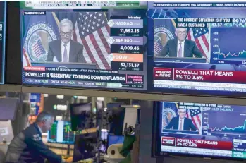  ?? — Reuters ?? A news conference held by Federal Reserve Chair Jerome Powell is displayed at the New York Stock Exchange.